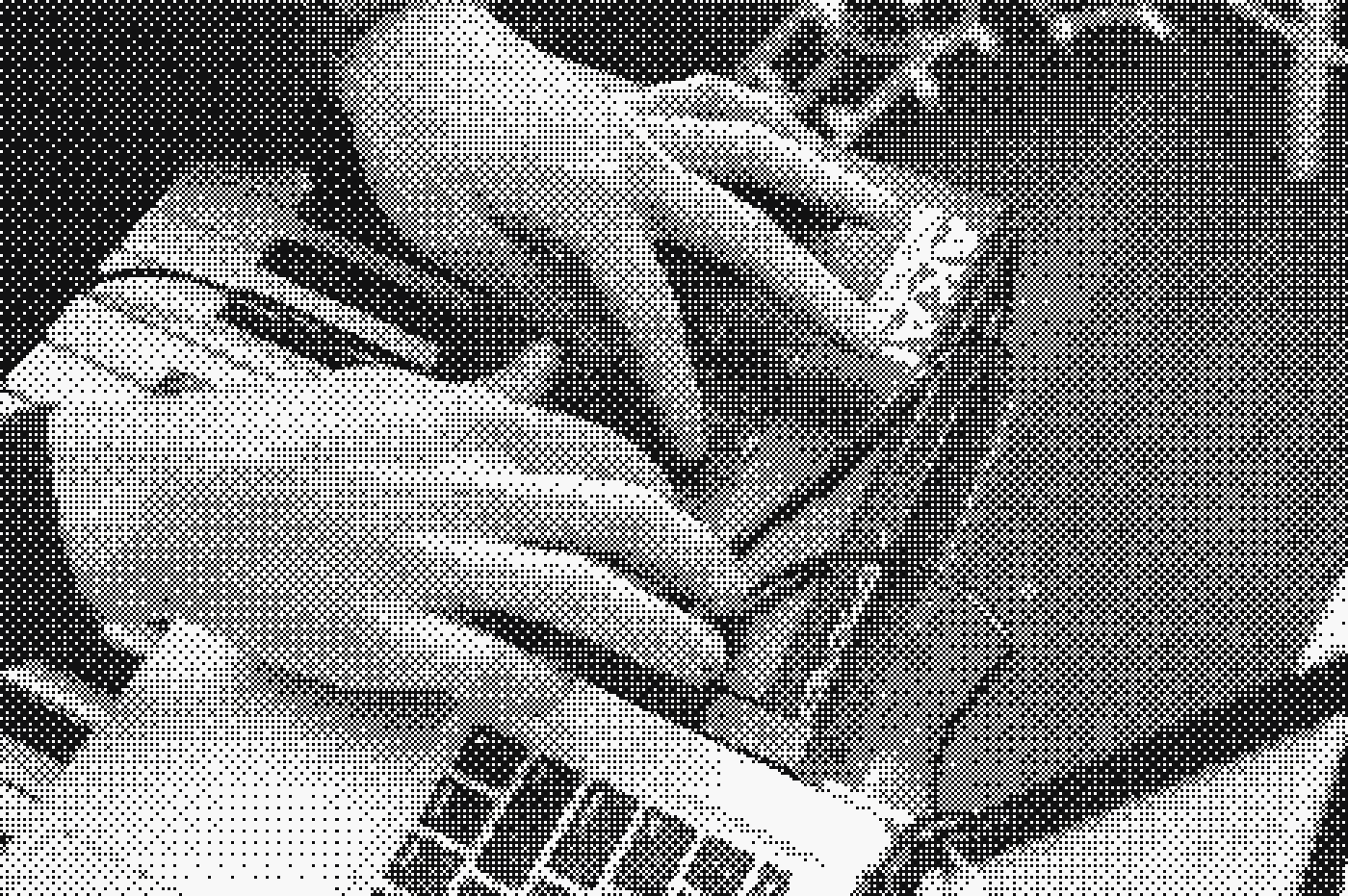 Hands on a controller beside a laptop